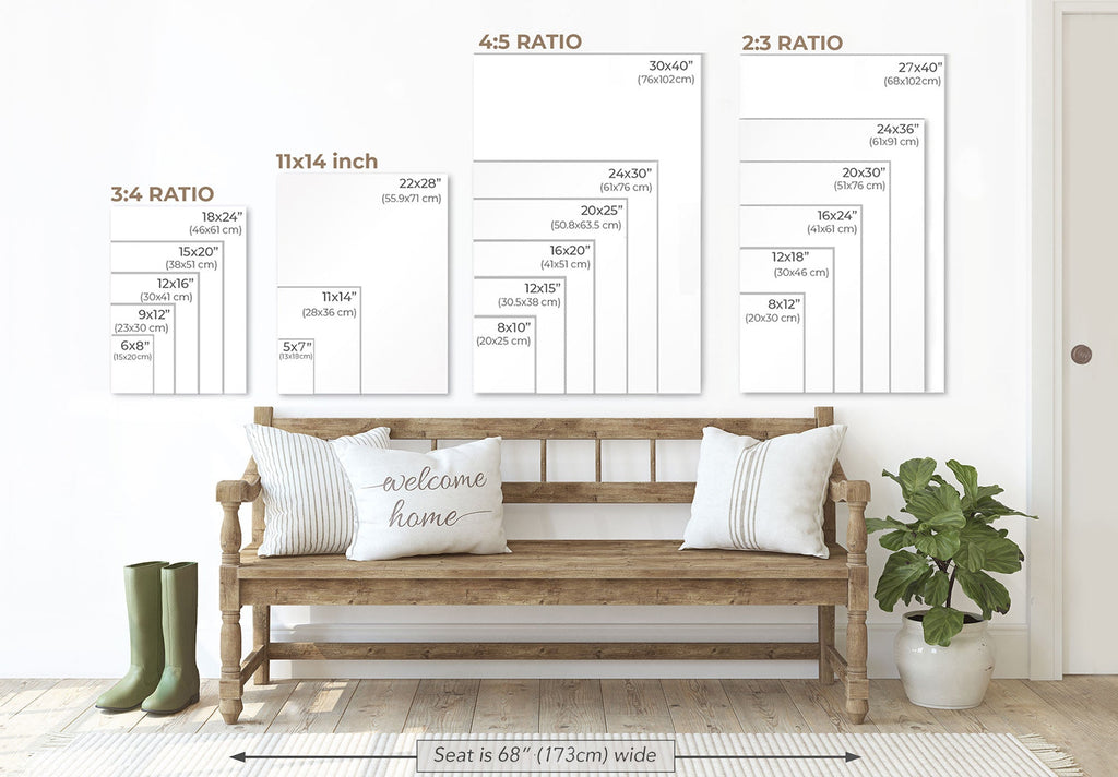 a wooden bench with pillows, a potted plant, and a pair of boots, all set against a white wall. Above the bench, there are three framed size charts providing measurements for different print sizes, including 3/4, 11/14, and 2/3 ratio prints.